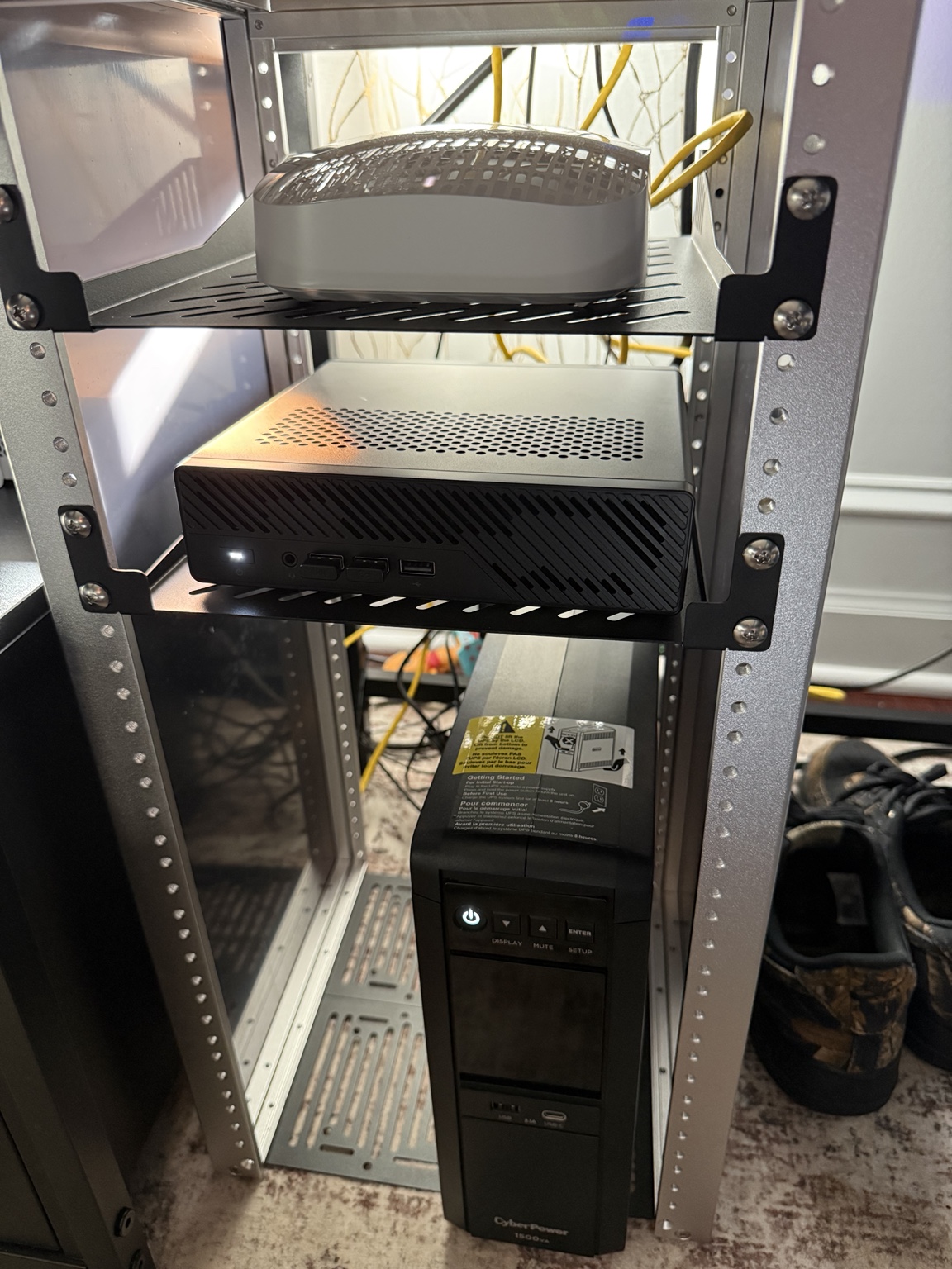 MINISFORUM MS-A2, MikroTik router, and CyberPower UPS installed in the compact home lab rack